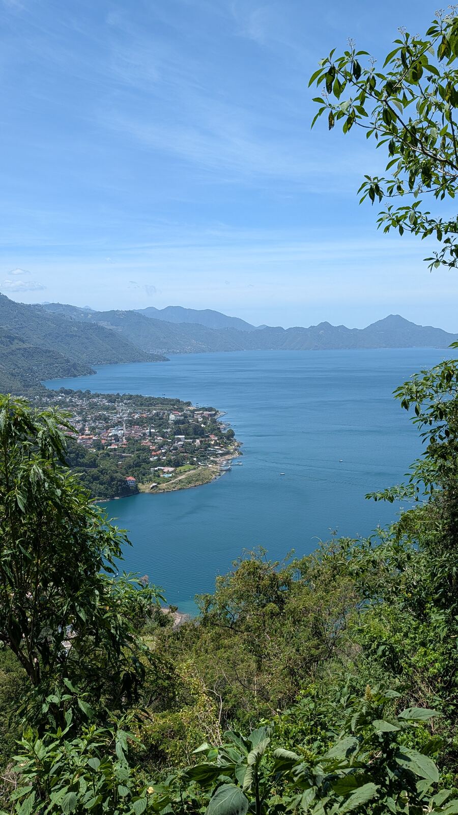 The lake seen from the forest, far below through the trees